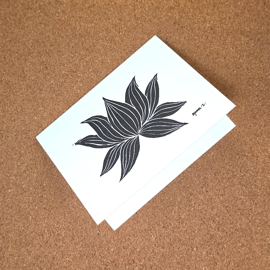Notecard featuring a digital print reproduction of an original hand-carved block print artwork of a lotus. Black and white artwork.