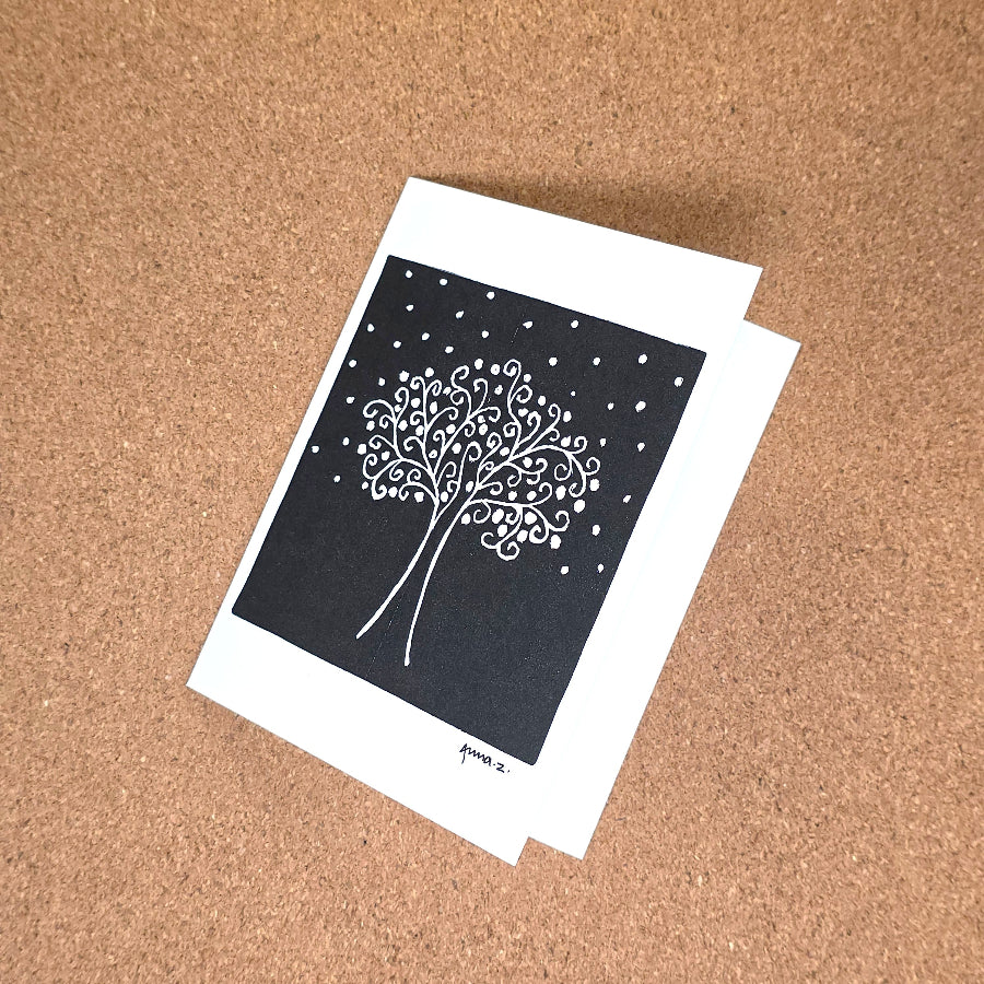 Notecard featuring a digital print reproduction of an original hand-carved block print artwork of a tree with swirly branches against a starry sky. Black and white artwork.
