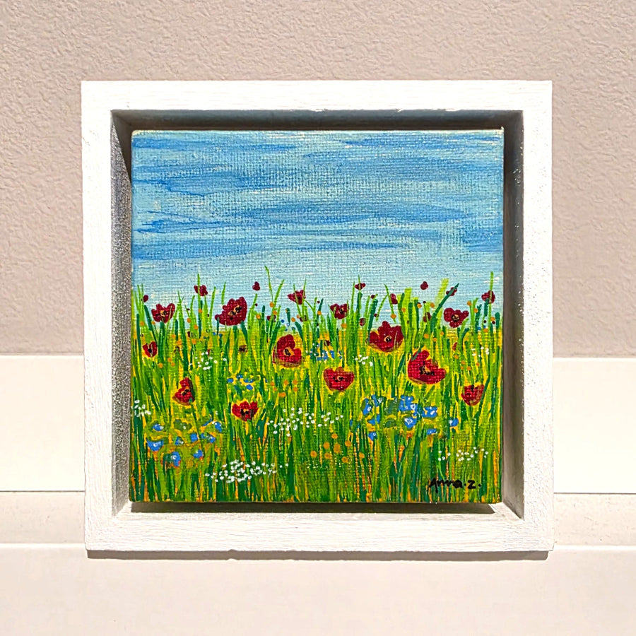 A burst of beautiful little wildflowers in red, blue, yellow and white in a grassy meadow, on a cool spring morning.
Mounted in floater frame style within a 5" x 5" rustic wooden box frame with mini sawtooth hanger on reverse. This joyful little springtime scene is perfectly complemented by the matte white wooden frame.