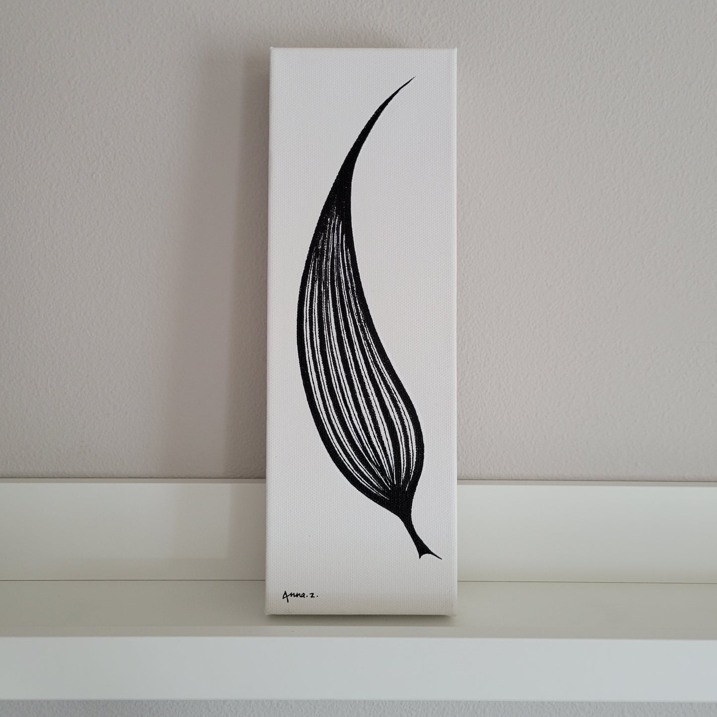 Artwork of a single elongated leaf shaped like a blade.