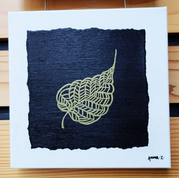 Intricate metallic block print of leaf veins embossed on a black background. Deep gold colored embossing on black cardstock and white canvas.