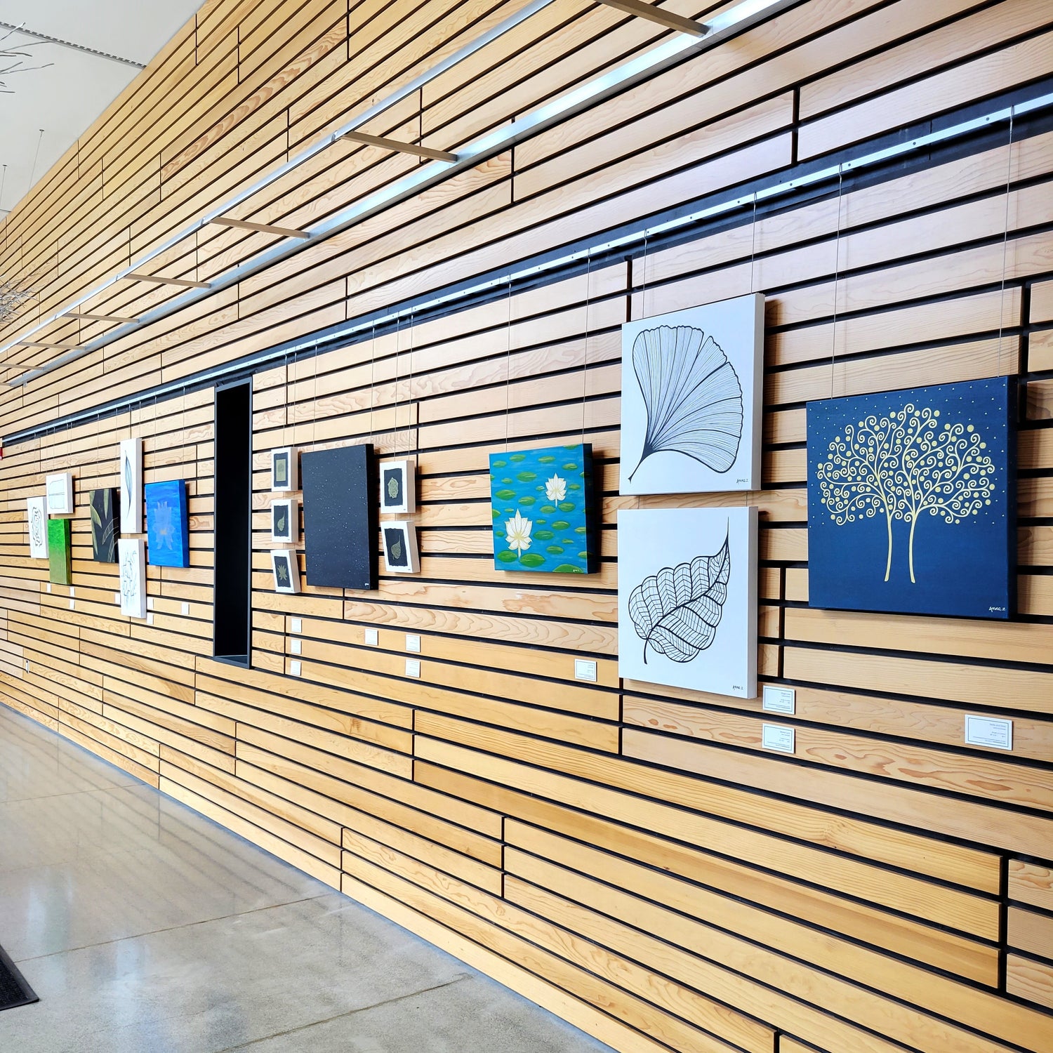 Image from gallery show depicting various artworks on display on the gallery wall.