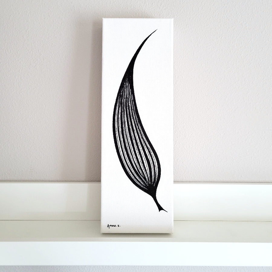 Artwork of a single elongated leaf shaped like a blade. Venation with thick and thin line details brings in a hint of optical illusion. Front view of canvas on picture ledge.