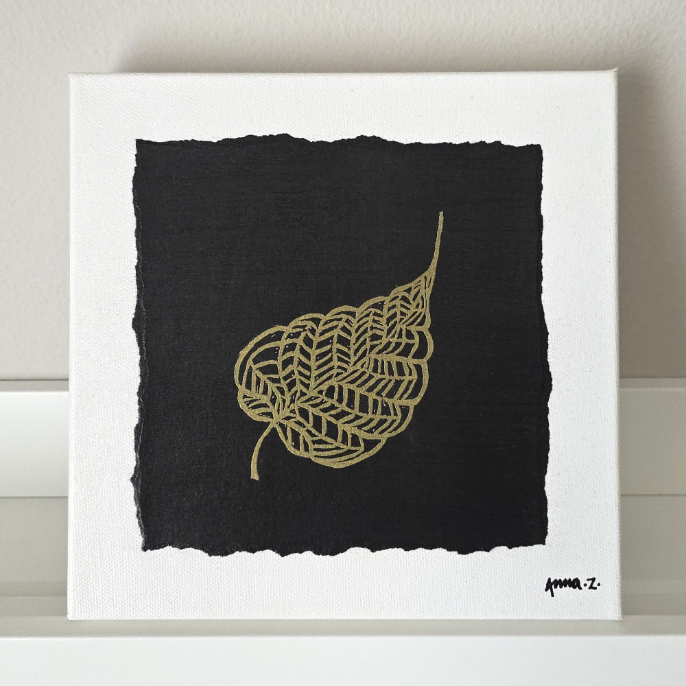 Intricate metallic block print of leaf veins embossed on a black background. Deep gold colored embossing on black cardstock and white canvas.