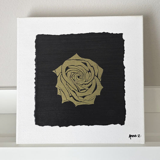 Intricate metallic block print of a rose embossed on a black background. Deep gold colored embossing on black cardstock and white canvas.