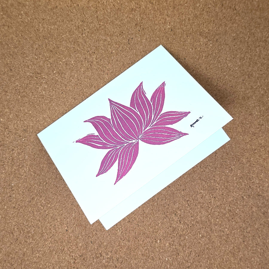 Notecard featuring a digital print reproduction of an original hand-carved block print artwork of a lotus. Deep pink and white artwork.