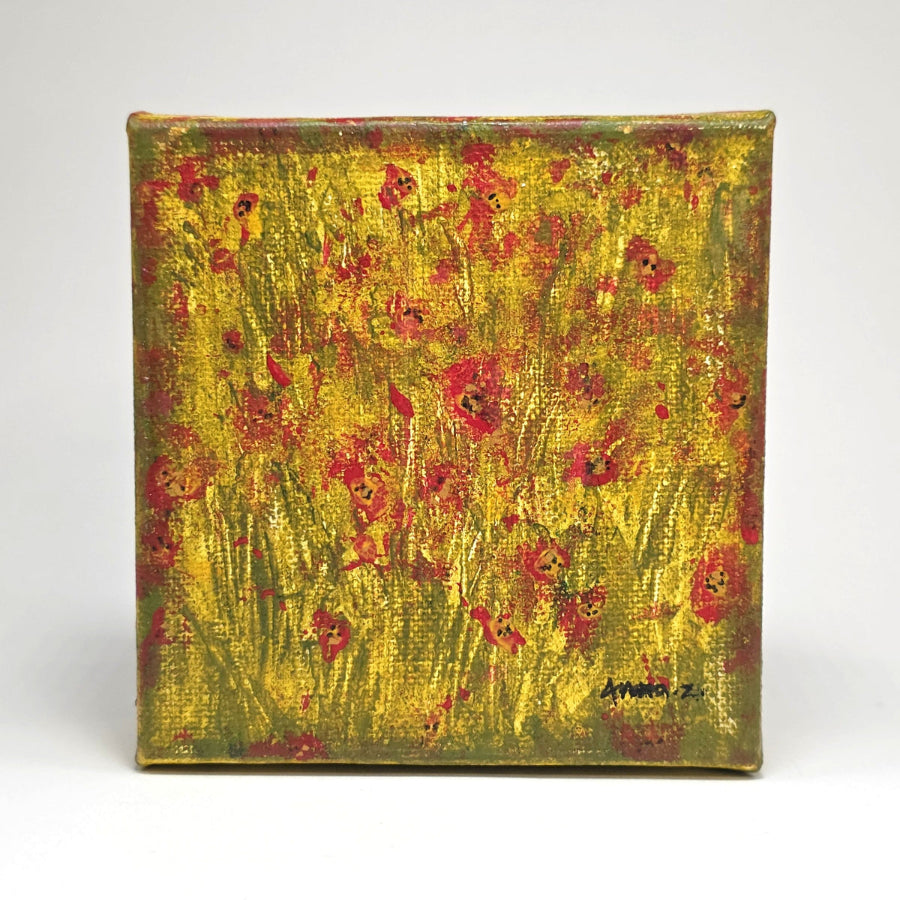 Front view of a mini painting of bright colored poppies in the glow of the summer sun. A warm grassy meadow completes the atmosphere of this dreamy mini painting in an abstract style.