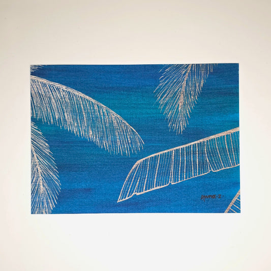 Botanical themed art print of golden yellow coconut palm fronds and banana leaves framing a deep blue background with hints of green.