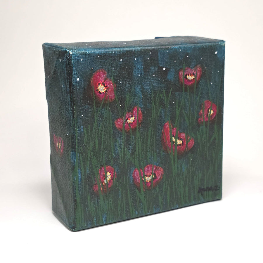 Angled side view of a dreamy mini painting of bright colored poppies take on a magenta hue in cool starlight. Grasses in foreground, and a starry sky with soft hazy clouds in the background. 