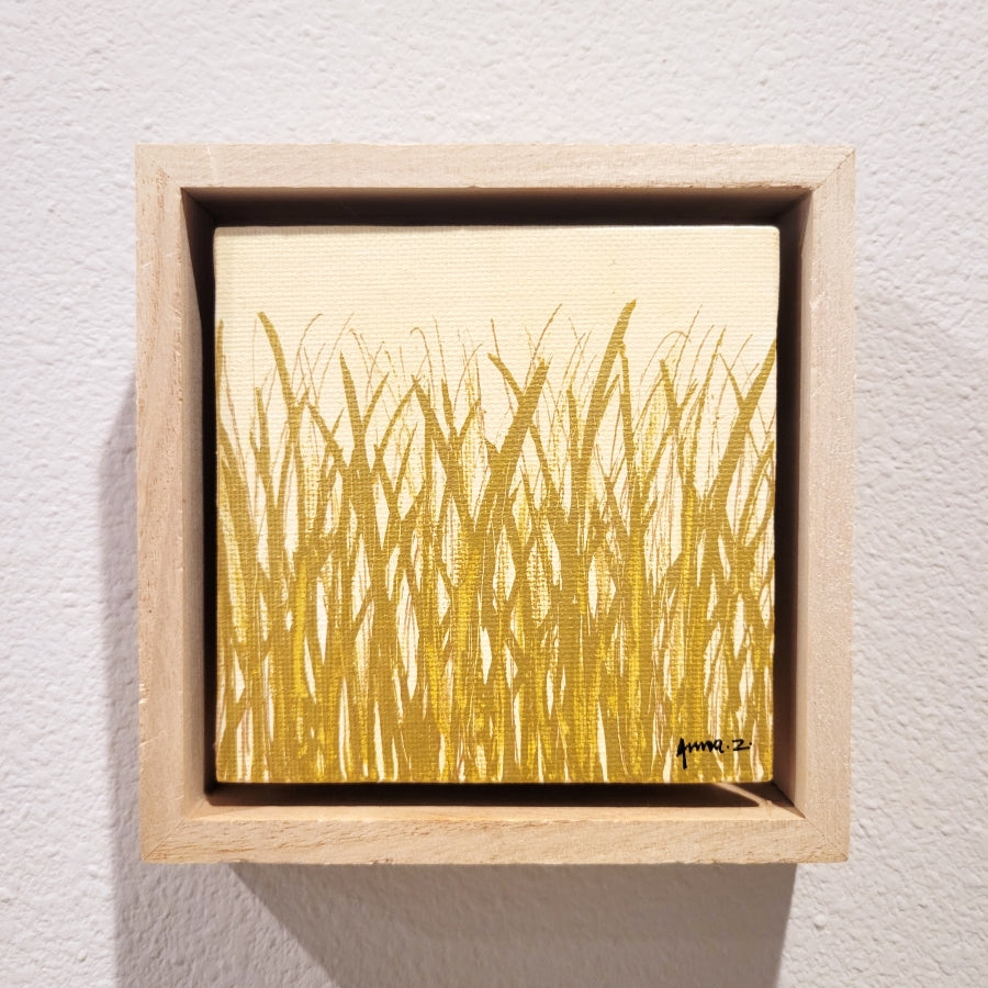 Golden blades of grass set against a cream background on a framed mini-sized canvas panel. Metallic gold colored paint over acrylic.  Mounted in floater frame style within a 5" x 5" rustic wooden box frame with mini sawtooth hanger on reverse. The golden grass catches daylight beautifully and is perfectly complemented by the light colored wooden frame. 