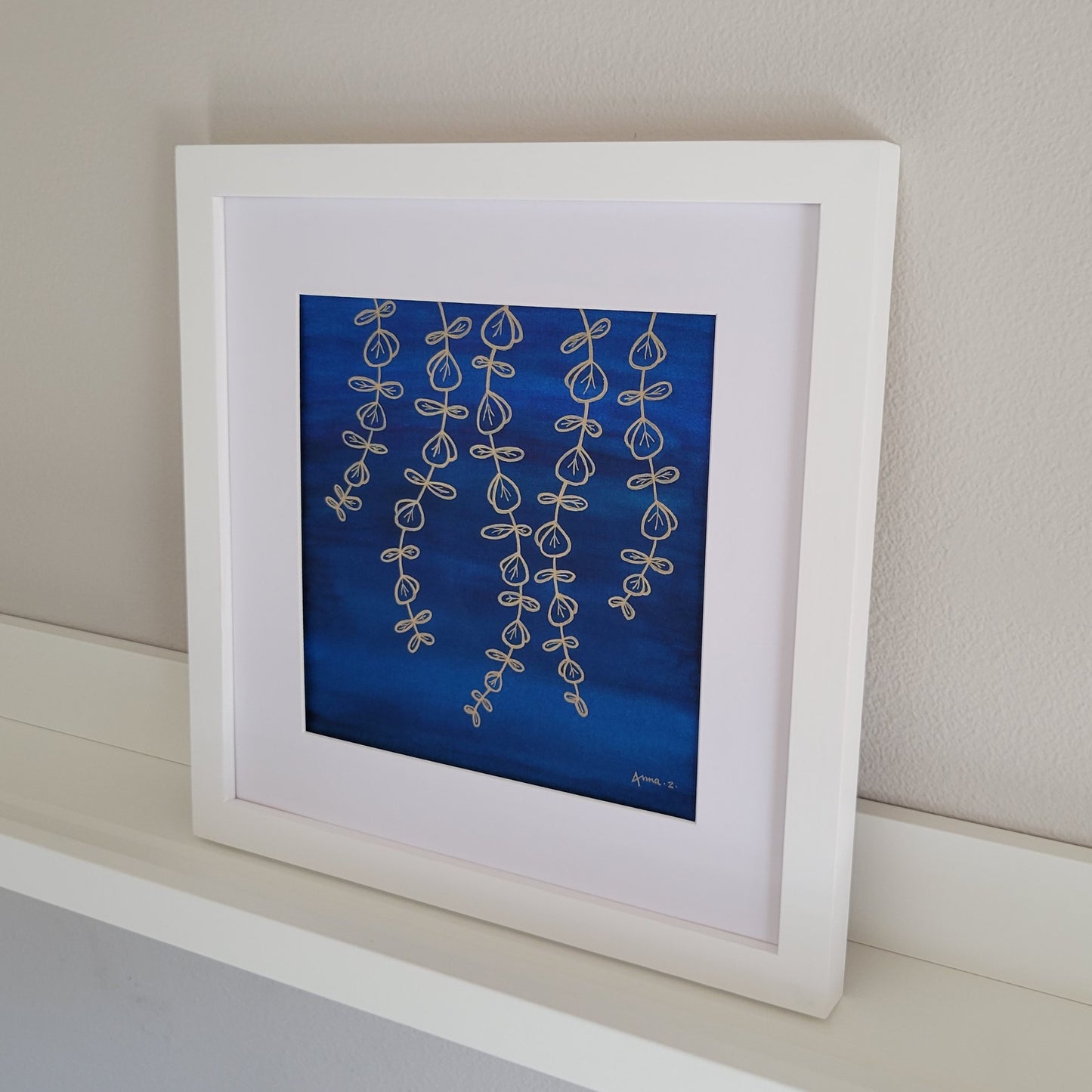 Golden leafy tendrils hanging in the breeze, with some veining detail on the oval leaves. In metallic ink set against a deep blue watercolor background with hints of green, this color combination creates a perfect balance of richness and minimalism. This piece has exactly 100 leaves, either fully or partially visible.