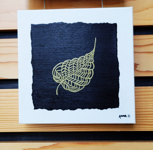 Intricate metallic block print of banyan leaf veins embossed on a black background. Deep gold colored embossing on black cardstock and white canvas.