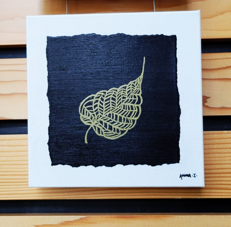 Intricate metallic block print of leaf veins embossed on a black background. Deep gold colored embossing on black cardstock and white canvas.