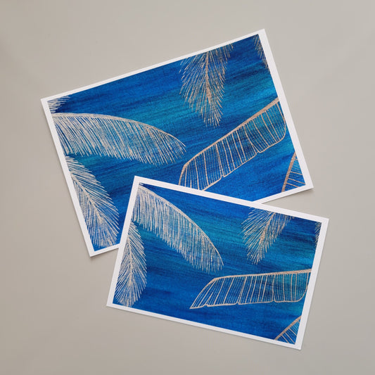 Botanical themed art print of golden yellow coconut palm fronds and banana leaves framing a deep blue background with hints of green. Adapted from original painting. Delicate details set against a bold background, in a strong yet serene atmosphere. High quality print reproduction on specialty fine art printing paper.