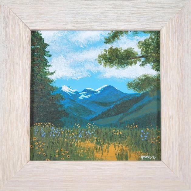 Original painting by Annazach Art. Miniature painting of distant mountains, framed by wildflowers and tall trees in the foreground, as seen from the top of Sun Mountain in Winthrop, Washington. 