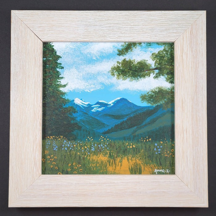 Original painting by Annazach Art. Miniature painting of distant mountains, framed by wildflowers and tall trees in the foreground, as seen from the top of Sun Mountain in Winthrop, Washington. 
