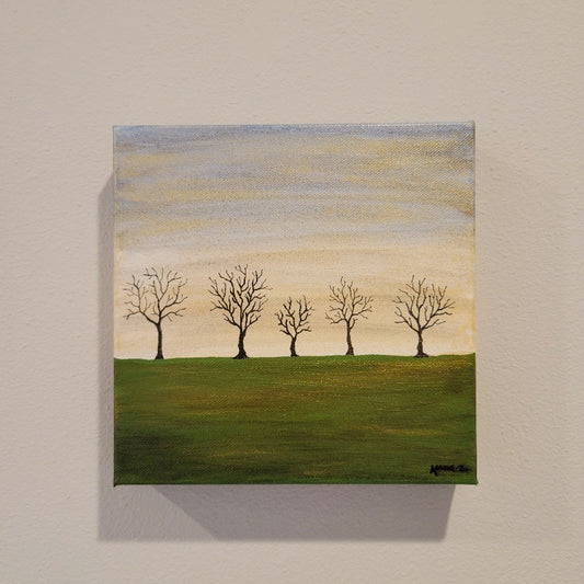 A dreamy landscape of bare trees against a golden twilight horizon and deep green fields. Subtle metallic highlights add interest and atmosphere.